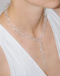 Model wearing bold transparent glass chain necklace with drop detail, handmade borosilicate links and sterling silver clasp.