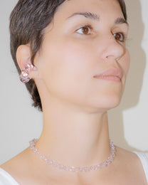 Model wearing handmade thin borosilicate necklace in pink with sterling silver clasp.