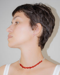 Model wearing two-tone transparent and red glass chain necklace styled as a choker, handmade thin borosilicate links with sterling silver clasp.