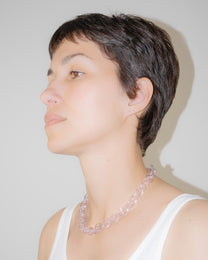 Model wearing bold glass chain necklace in pink, handmade borosilicate links with minimal, timeless design.