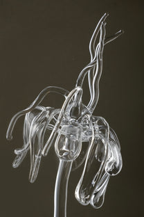 Close-up of transparent Orb Necklace showing solid glass spheres connected seamlessly with glass links, handmade borosilicate piece.