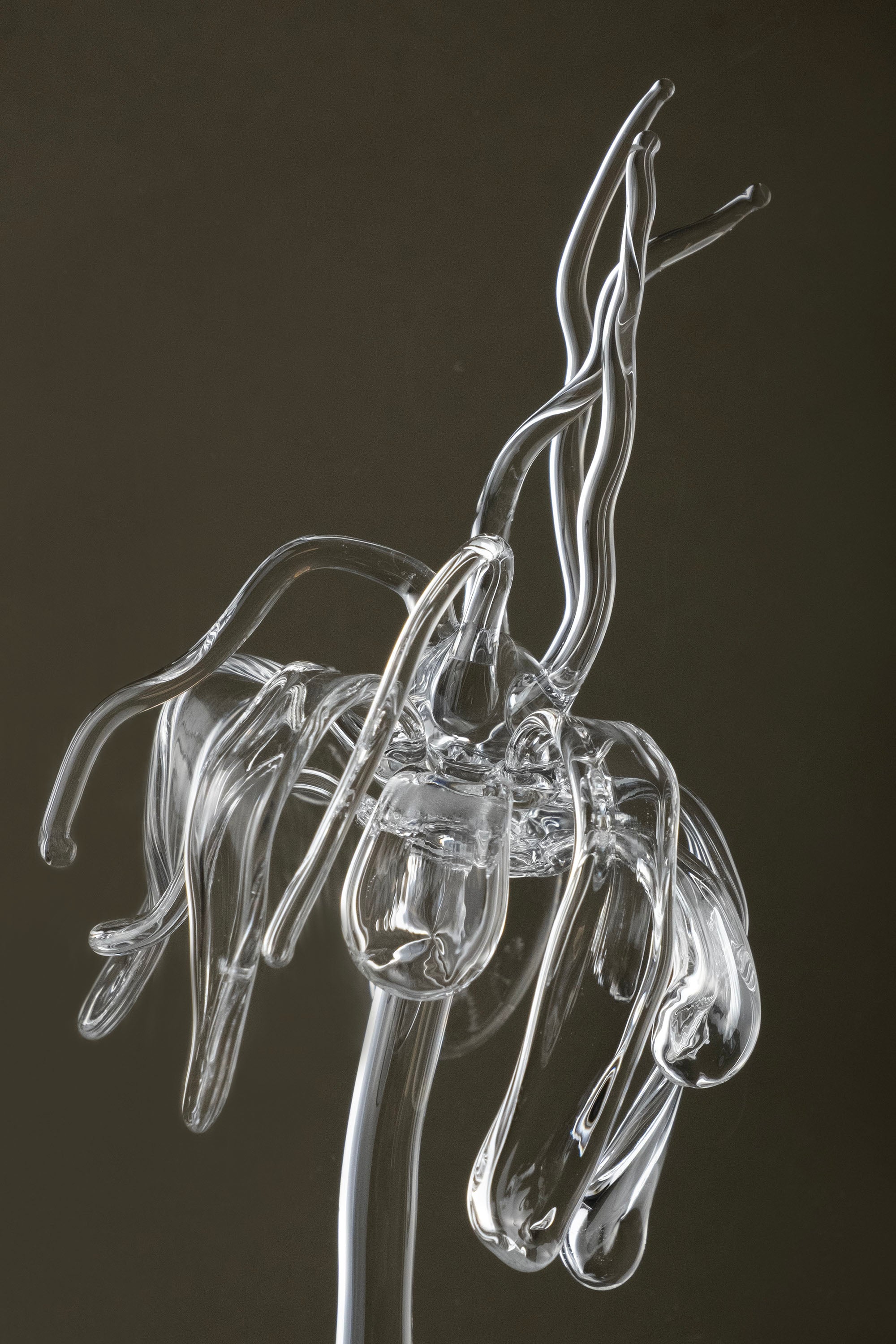 Close-up of transparent Orb Necklace showing solid glass spheres connected seamlessly with glass links, handmade borosilicate piece.