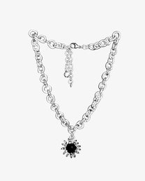 Bold glass chain necklace with black glass amulet, featuring a central sphere surrounded by transparent loops, handmade borosilicate jewelry.