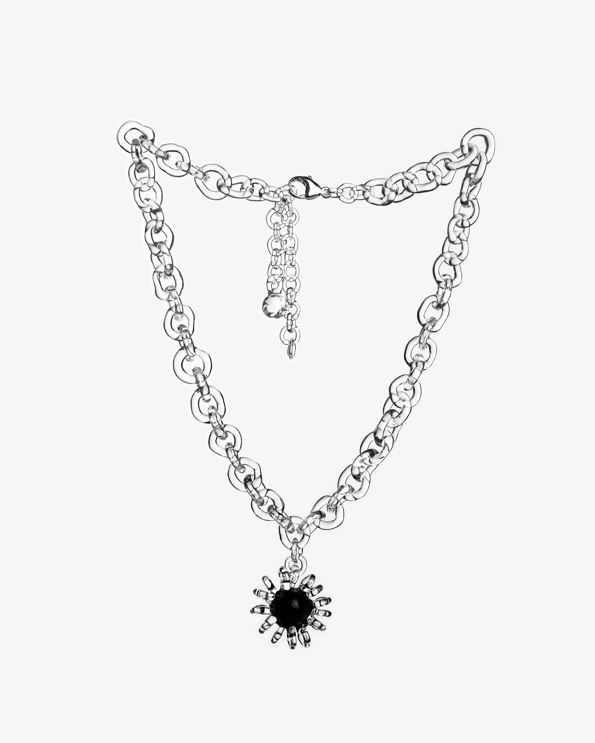 Bold glass chain necklace with black glass amulet, featuring a central sphere surrounded by transparent loops, handmade borosilicate jewelry.