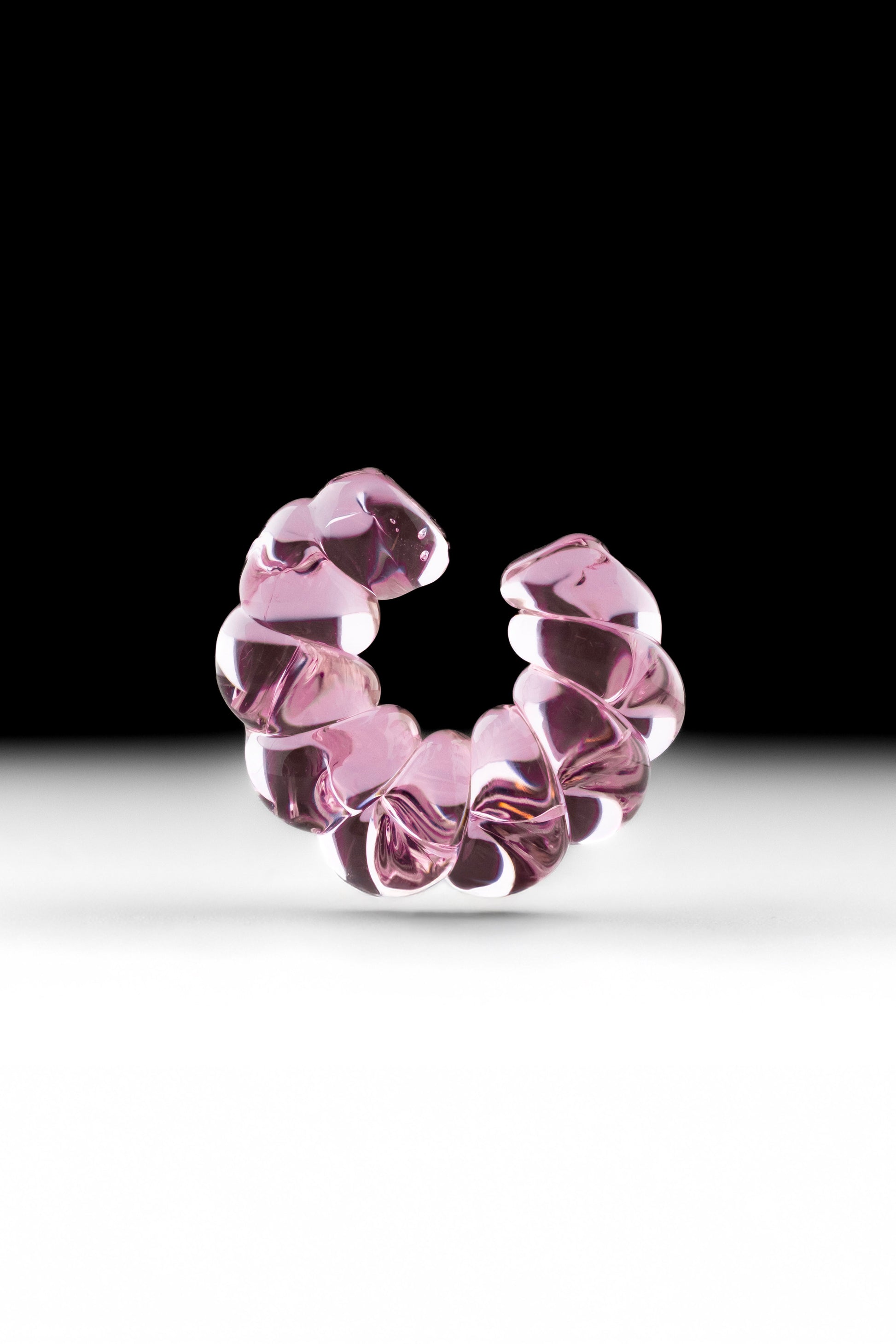 Twisted borosilicate glass ear cuff in pink color.