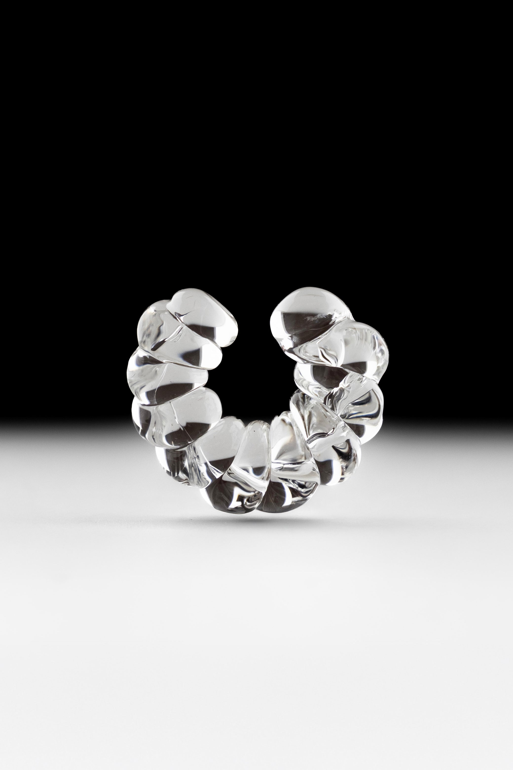 Handmade glass ear cuff in clear transparent color.