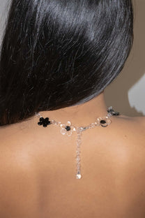 Handmade black glass flower necklace worn as a choker