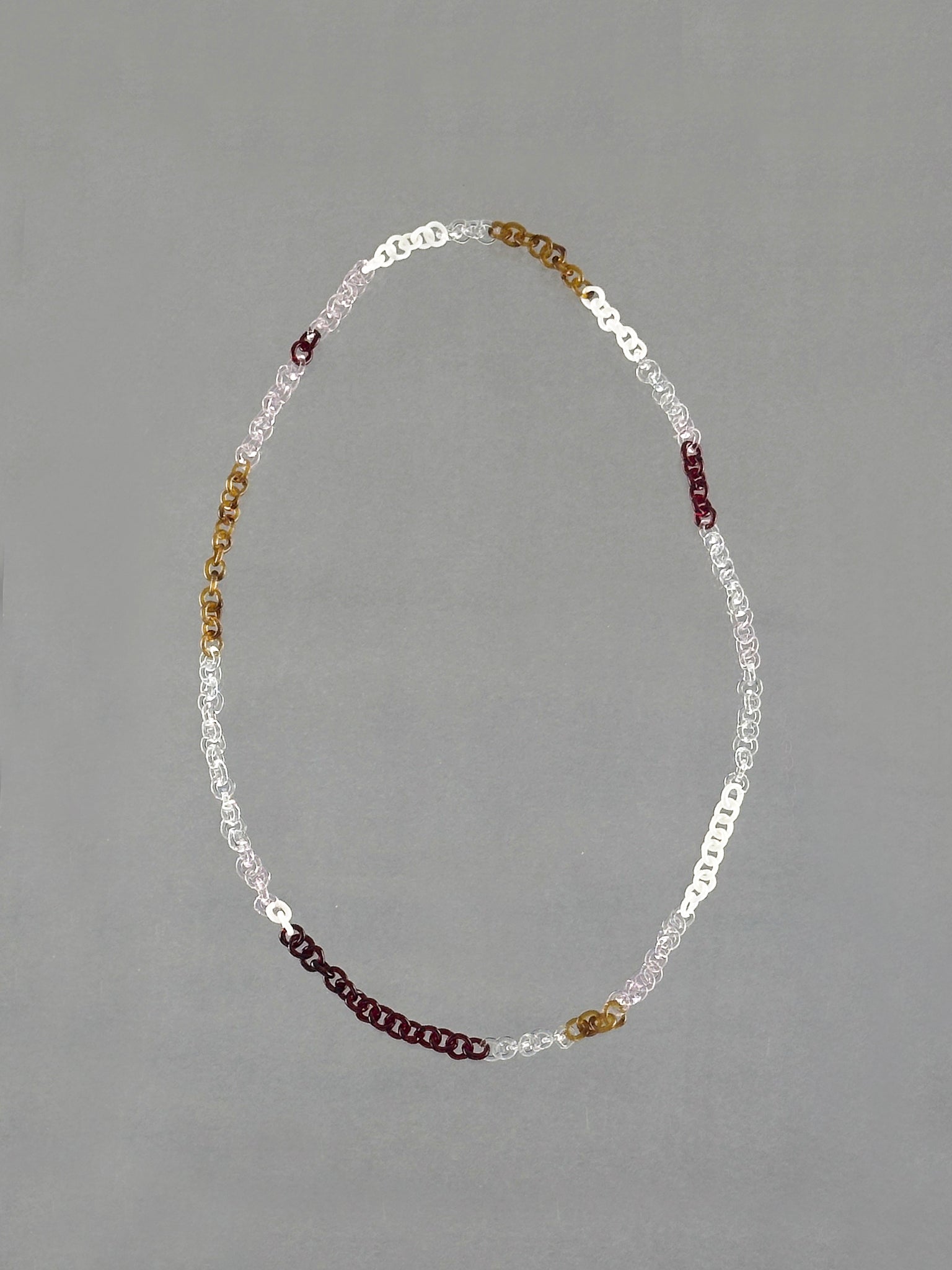 Handmade Sequence Necklace featuring borosilicate glass links in amber, red, pink, white and transparent glass. A unique 75 cm necklace.