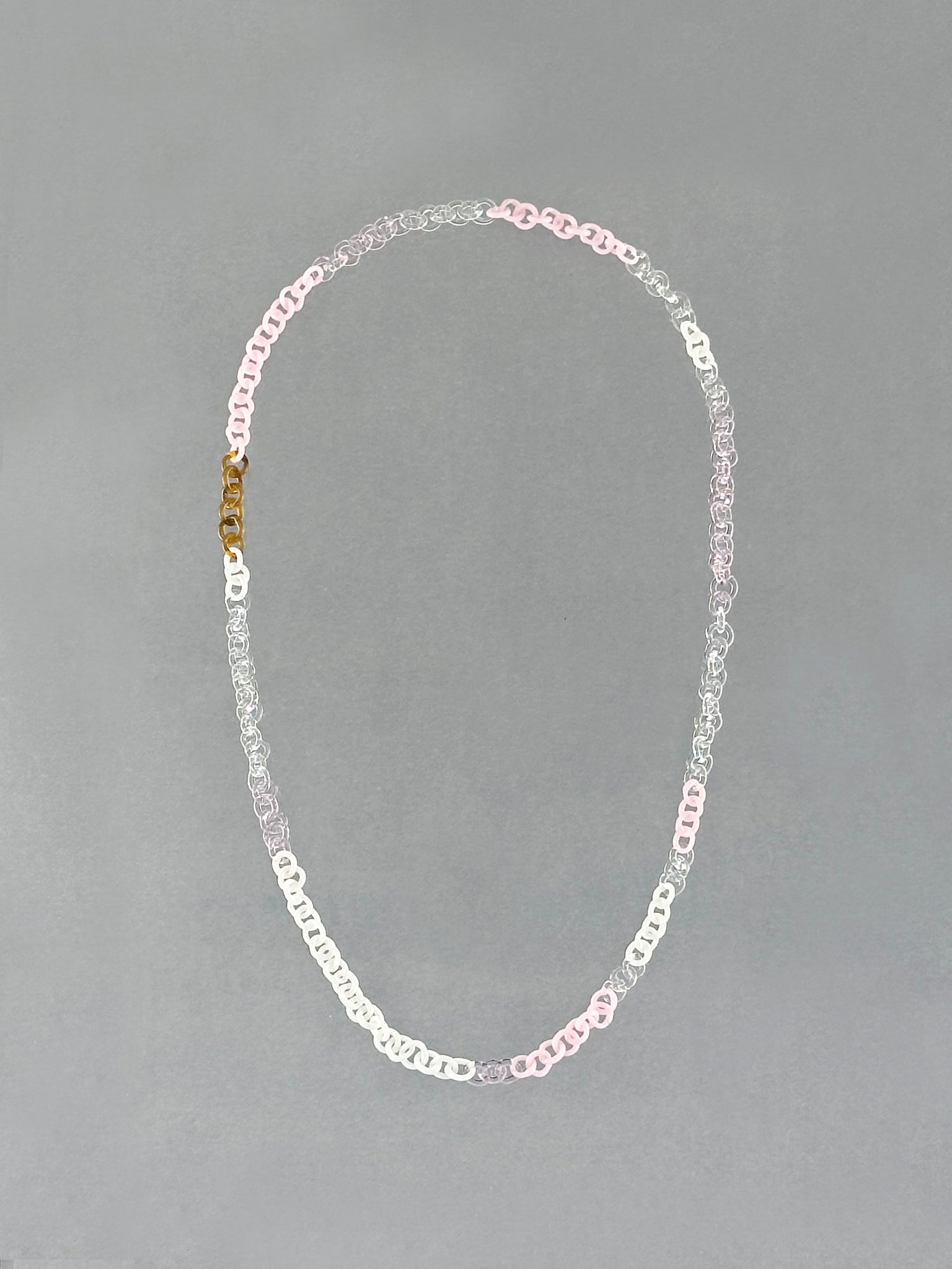 Unique Sequence Necklace handcrafted from borosilicate glass with amber, pink, opaque pink, white and transparent glass links.