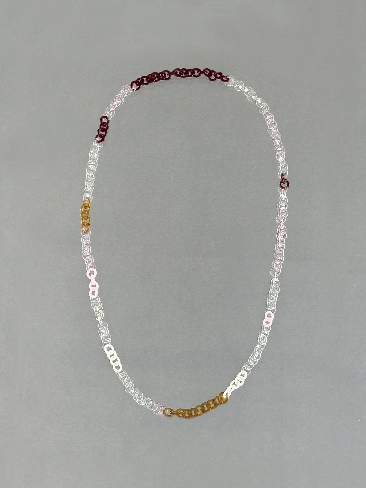 One-of-a-kind Sequence Necklace made from handmade borosilicate glass links in amber, red, pink, white and transparent colours.