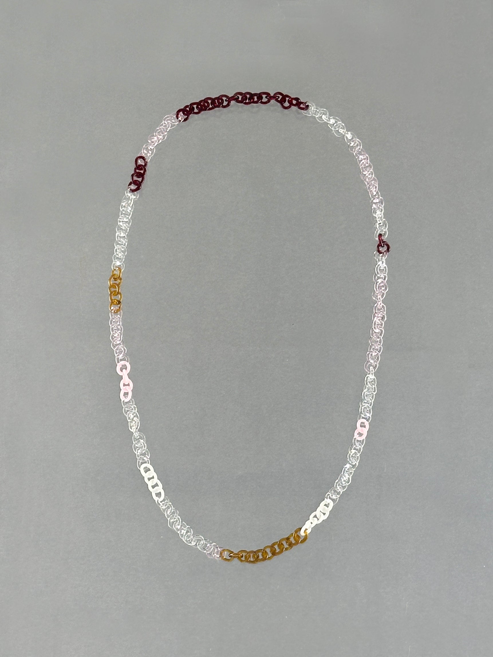 One-of-a-kind Sequence Necklace made from handmade borosilicate glass links in amber, red, pink, white and transparent colours.