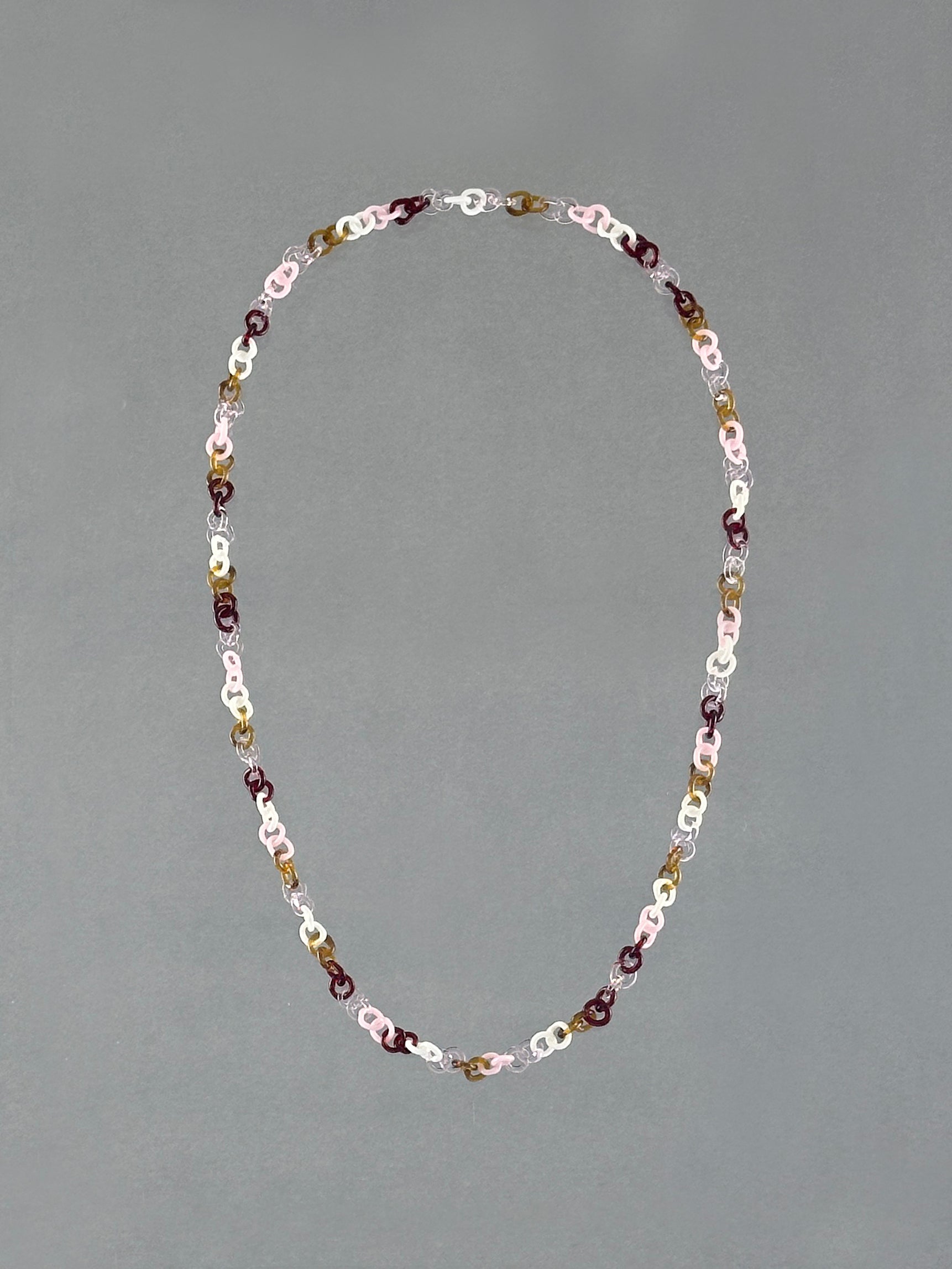 Handmade Sequence Necklace featuring a unique sequence of borosilicate glass links in amber, red, pink, white and transparent glass.