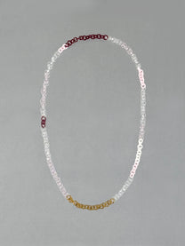 Handmade Sequence Necklace made from borosilicate glass links in amber, red, pink, opaque pink, white and transparent glass.