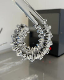 Making off a transparent glass ear cuff with dots.